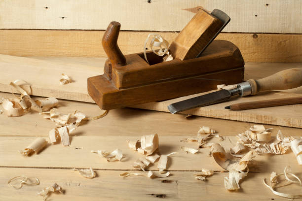istock Carpentry concept.Joiner carpenter workplace. Construction tools on wooden table with sawdust. 895142384