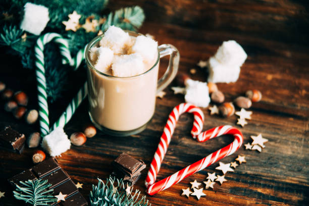 istock Cup with Christmas hot Chocolate drink, Marshmallows and cinnamon on wooden bright background. Holiday Gift concept, Top view 895142886