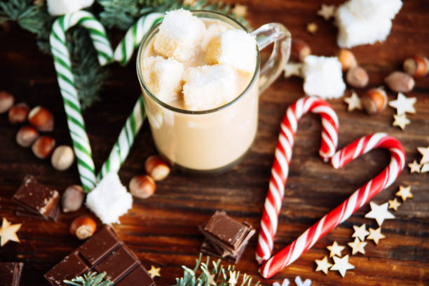 istock Cup with Christmas hot Chocolate drink, Marshmallows and cinnamon on wooden bright background. Holiday Gift concept, Top view 895142904