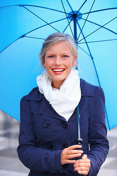 istock young girl holding a blue umbrella 89514530