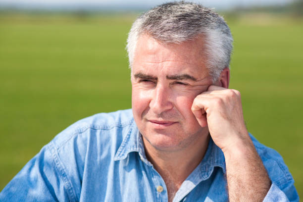 istock Handsome mature man leaning on fence. 895145398