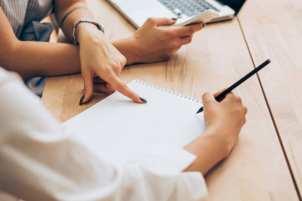 istock Businesswoman holding a pen and pointing . 895145500