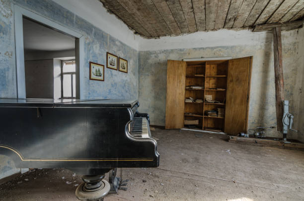 istock piano with box in abandoned house 895155404