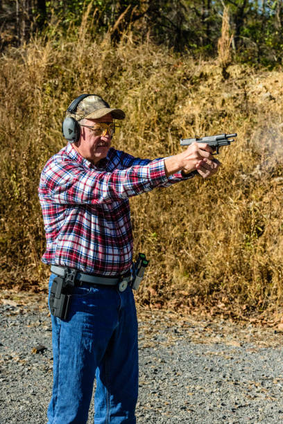 istock Standing man shoots a pistol 895155916