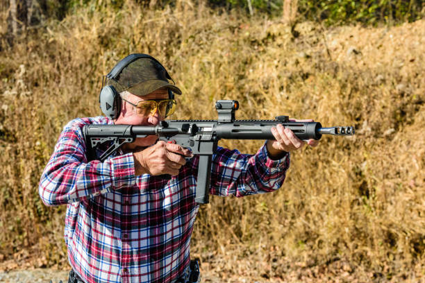 istock Man aiming pistol caliber carbine 895156552