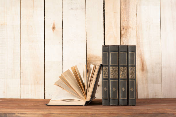 istock Open book, hardback books on wooden table. Education background. Back to school. Copy space for text. 895162692