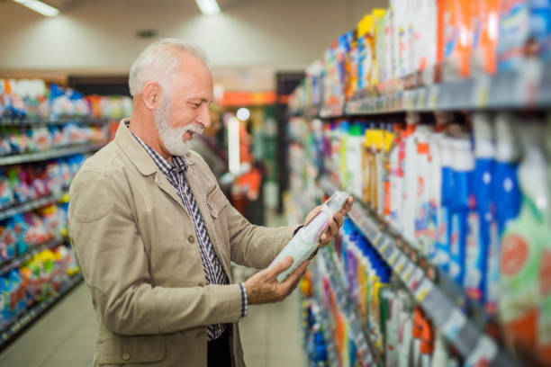 istock Senior man choosing household products in a store 895181164