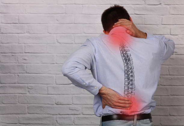 man suffering from back and neck pain. incorrect sitting posture problems, muscle spasm, rheumatism. pain relief , chiropractic concept. - lower back pain imagens e fotografias de stock