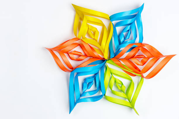 istock Beautiful snowflake from multi-colored paper on a white background 895205190