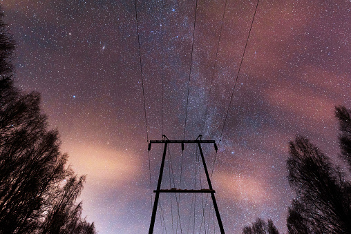 Power line under starry sky