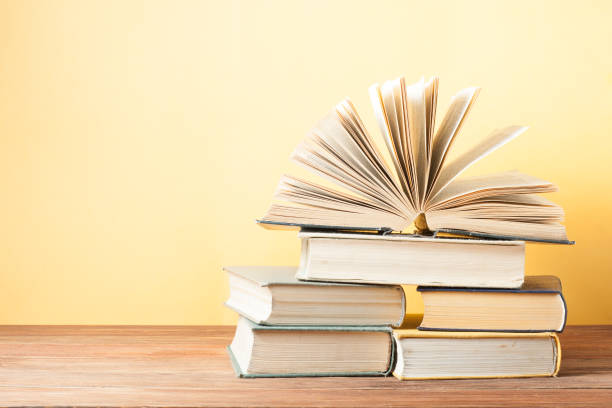 istock Open book, hardback books on wooden table. Education background. Back to school. Copy space for text. 895217444