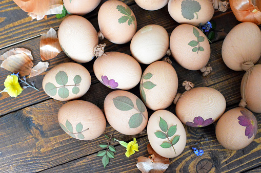 Coloring Easter eggs with onion, leaf pattern as decoration