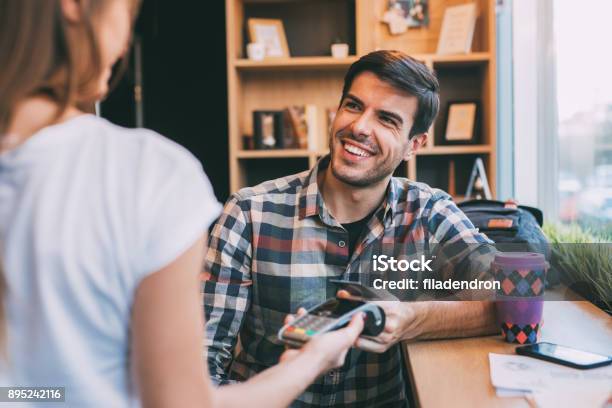 Man Paying Via Smart Phone Stock Photo - Download Image Now - Credit Card, Passing - Sport, Waiter