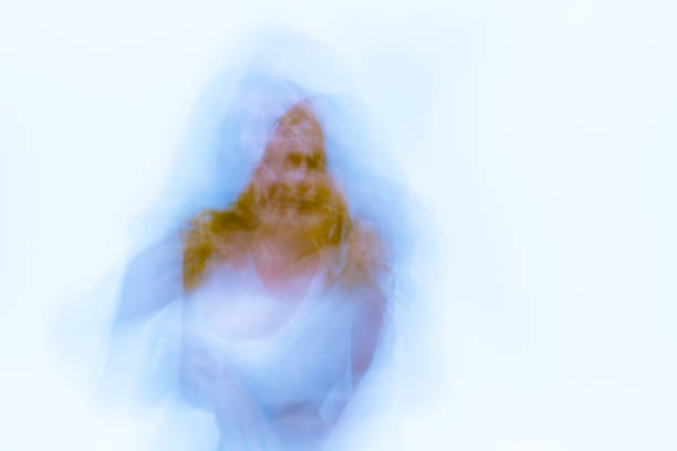 istock Blurred, double exposure abstract female form on white 895244700