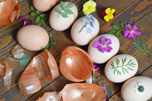 Easter eggs decorated with leaves and flowers