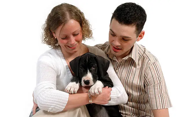 Photo of Young couple and puppy