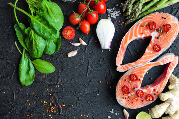 istock Two salmon steaks with vegetables and spices 895263222