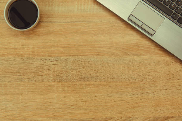 istock Laptop computer or notebook, binocular and cup of coffee on working table with copy space top view. 895263236