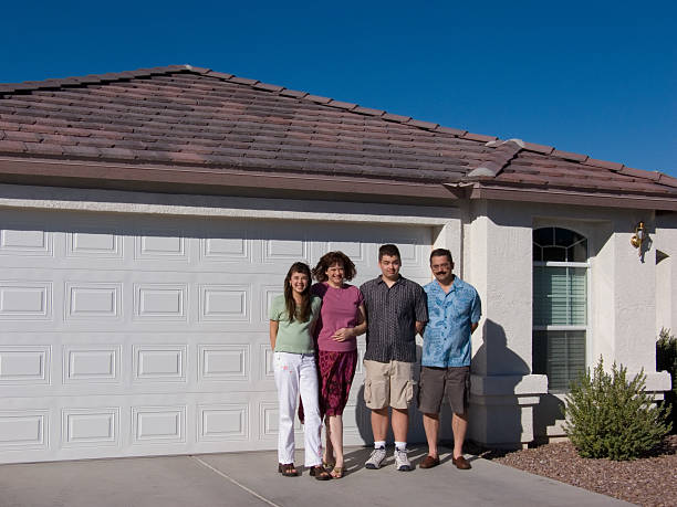 Family in front of garage stock photo