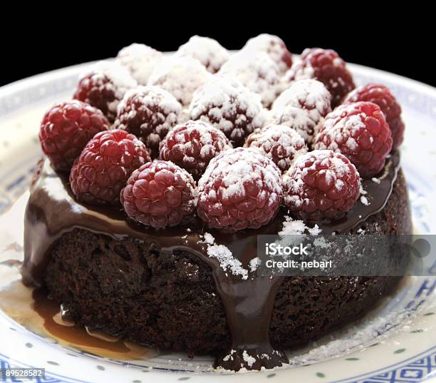 Small Chocolate Cake With Raspberries And Caramel Stock Photo - Download Image Now - Cake, Caramel, Chocolate