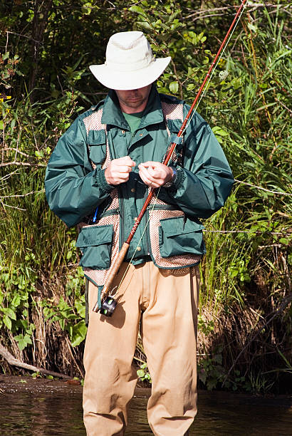 istock Fly Fisherman Tying on a Lure 89528866