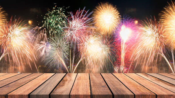 istock Abstract empty wooden floor with fireworks background. colorful fireworks over dark sky abstract for background. New Year celebration fireworks. 895291854