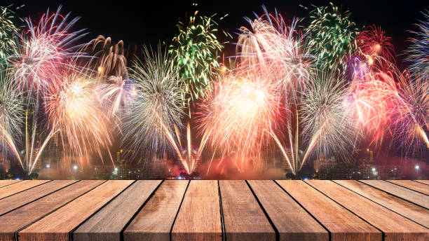 istock Abstract empty wooden floor with fireworks background. colorful fireworks over dark sky abstract for background. New Year celebration fireworks. 895291936