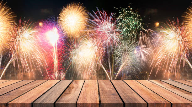 istock Abstract empty wooden floor with fireworks background. colorful fireworks over dark sky abstract for background. New Year celebration fireworks. 895291968