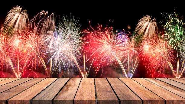 istock Abstract empty wooden floor with fireworks background. colorful fireworks over dark sky abstract for background. New Year celebration fireworks. 895291976