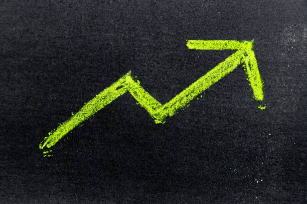 istock Green color hand drawing chalk in arrow up shape on black board background (Concept of revenue increase, stock or business growth) 895294022