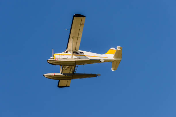 istock bottom view of the hydroplane flying in the blue sky 895299668