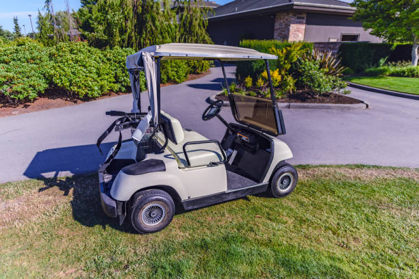 istock white electric golf cart standing on the grass 895302936