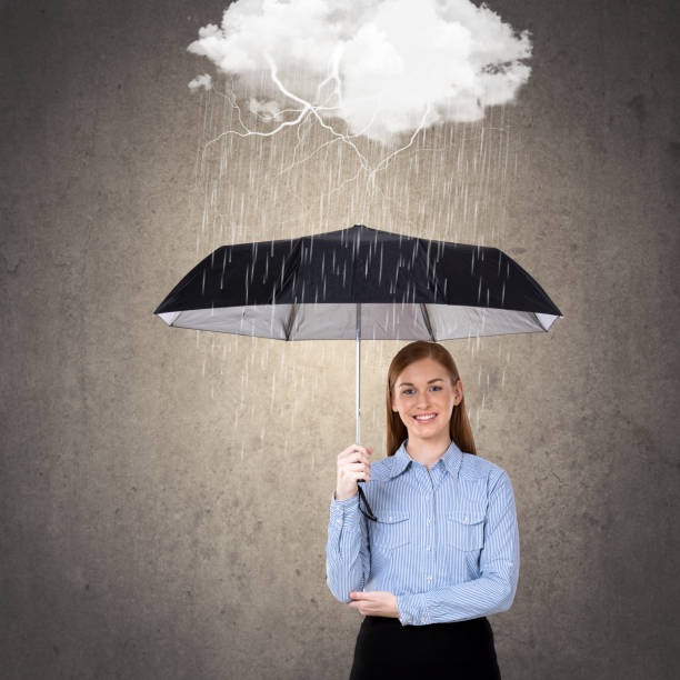 Open umbrella in pouring rain  Large threatening black clouds