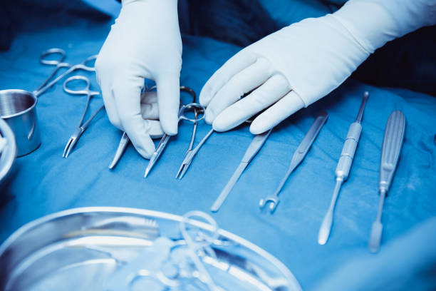 Close-up of scrub nurse taking medical instruments,surgery and emergency concept Surgery, Equipment, Human Hand, Medicine, Hospital, Metal, Steel, scalpel photos stock pictures, royalty-free photos & images