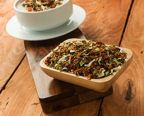 Mixture of dried vegetables in a wooden bowl. focus on vegetables