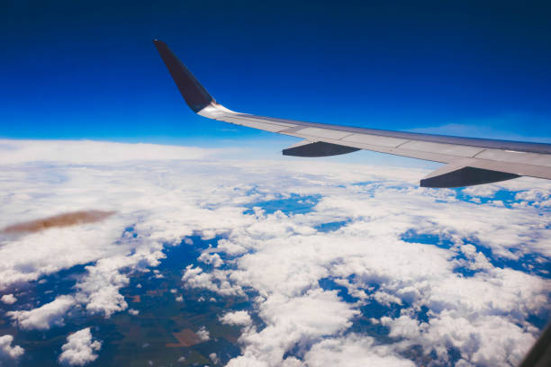 istock Plane wing above the clouds. Plane flying over the clouds 895372264