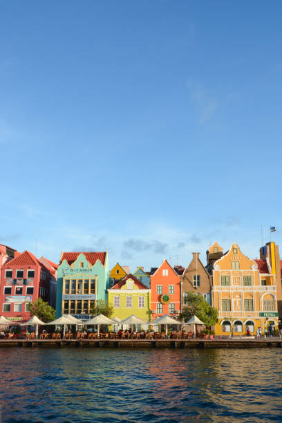 Colorful colonial architecture on Willemstad, Curacao's historic waterfront Early evening light warms the candy-colored buildings line the waterfront at this UNESCO World Heritage Site. curaçao stock pictures, royalty-free photos & images