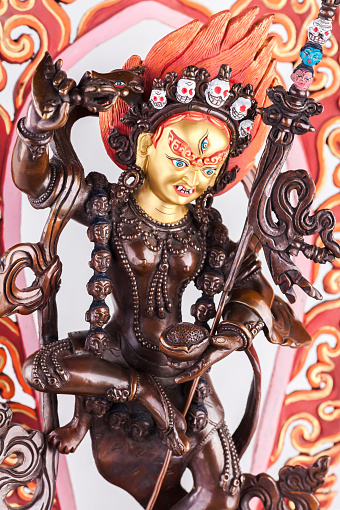 Yidam Red Tara in Vajrayogini's shape in a semi-angry form with the golden face and a knife cutting attachments.