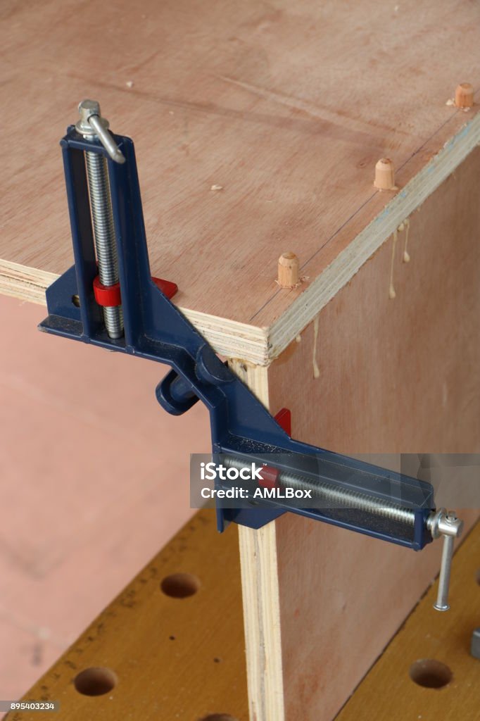 Assembling furniture, clamping Assembling furniture, clamping by miter clamp Glue Stock Photo