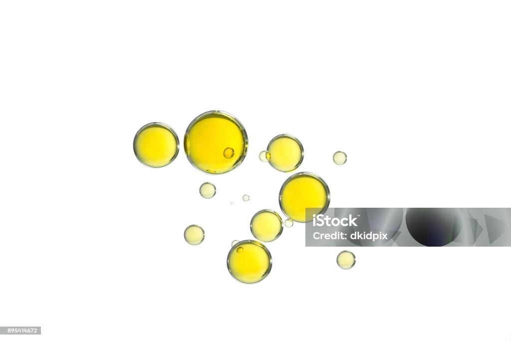 Yellow oil bubbles Yellow olive oil bubbles isolated over a white background. Cooking Oil Stock Photo