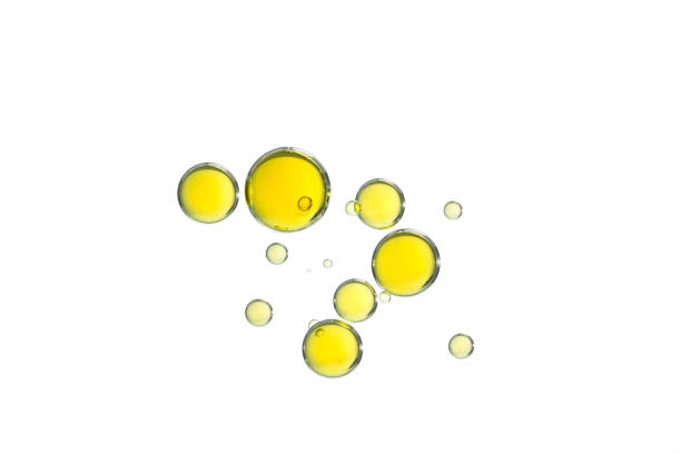 Yellow oil bubbles Yellow olive oil bubbles isolated over a white background. blood serum photos stock pictures, royalty-free photos & images
