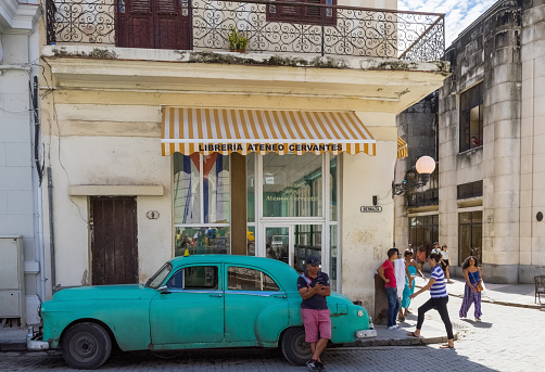Havana: Street life view with american Chevrolet green classic car and cuban peoples in Havana City Cuba  - Serie Cuba Reportage