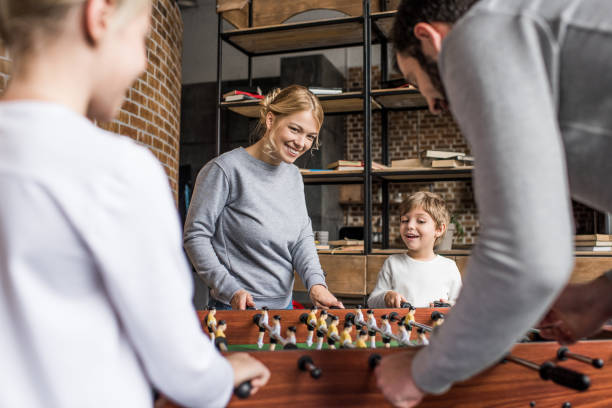 istock family playing table football 895438024