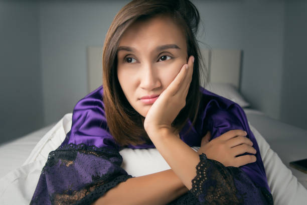 istock Asian woman in nightgown feel boring and sad about her husband problem every night. 895445830