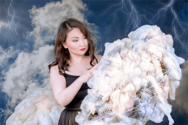 asian woman holding cloud in her hands and studing the motherboard silhouette pattern on the cloud. technology management concept.