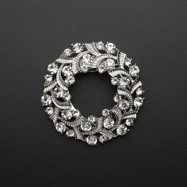 istock round brooch with diamonds isolated on black 895454248