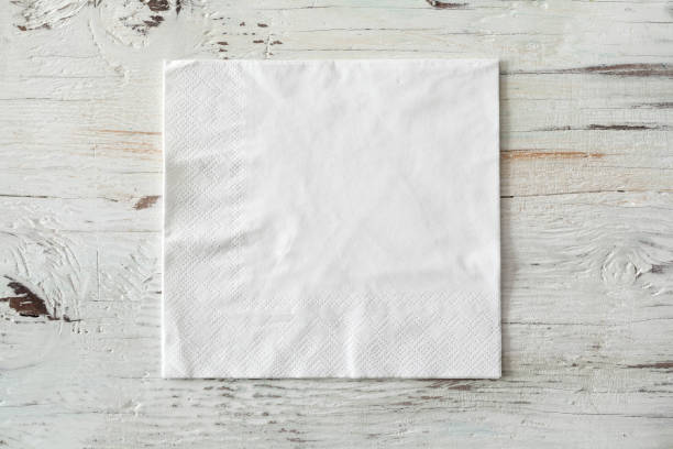 istock White paper napkin on wooden background 895454324