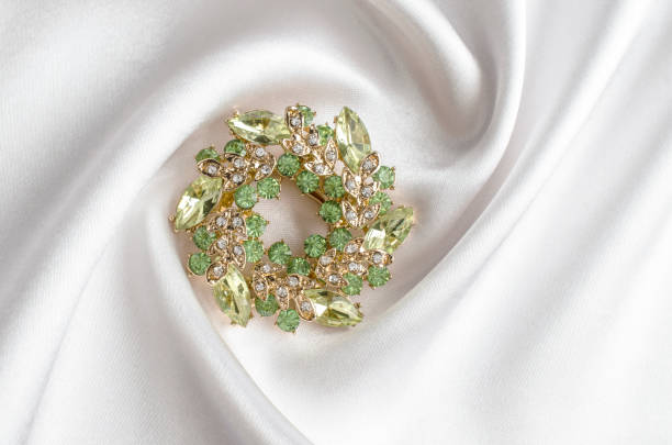 istock round brooch with gems isolated on a white silk 895454444