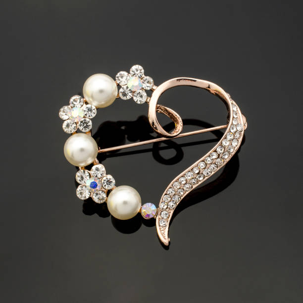 istock brooch heart with diamonds and pearls isolated on black 895454544