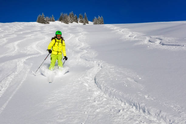 istock Skitouring downhill - powder skiing in Alps 895480496